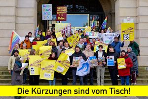Menschengruppe auf der Rathaustreppe mit Transparenten